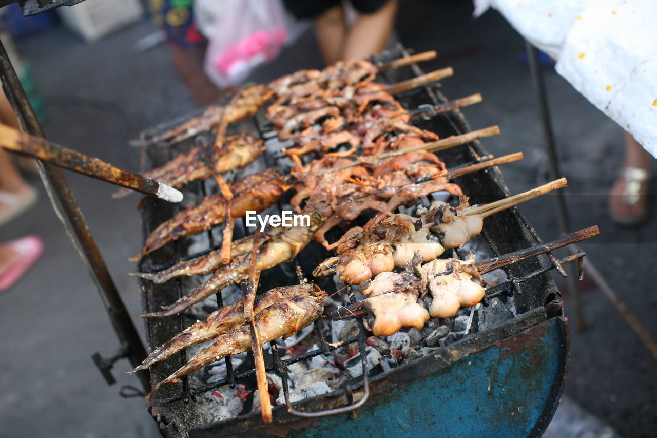 High angle view of meat on barbecue grill