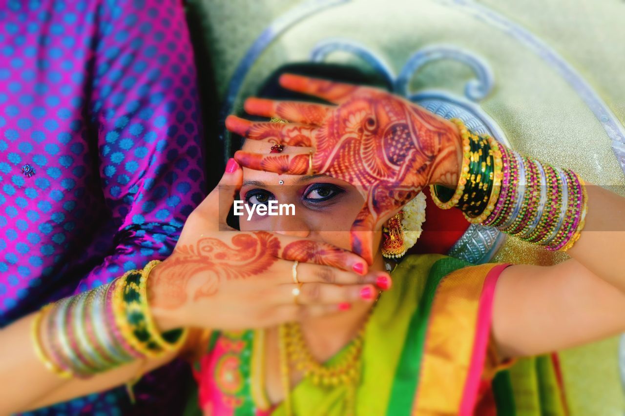 Close-up of young woman wearing mehndi