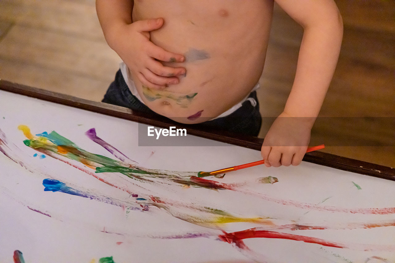 midsection of woman painting on floor