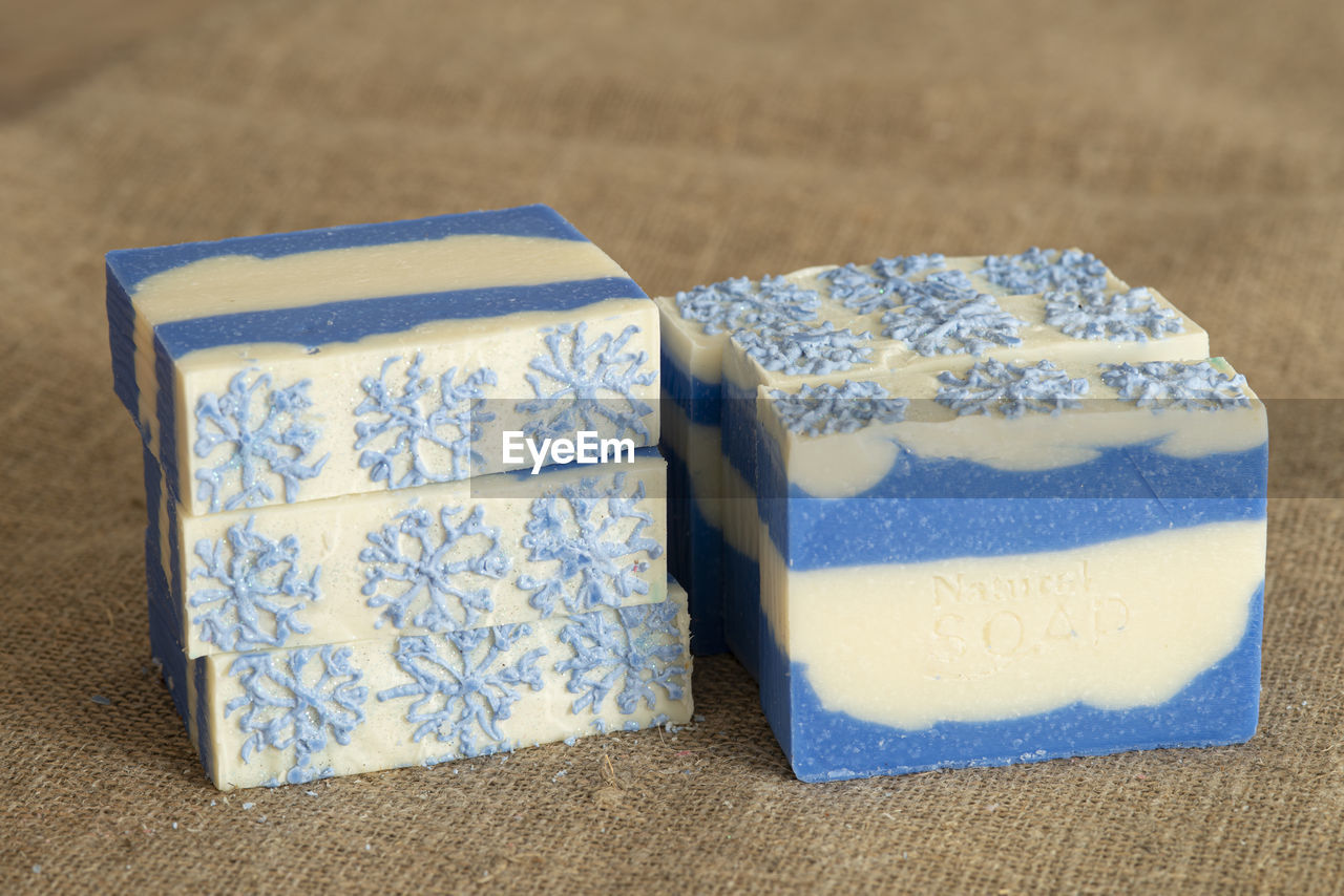 Original handmade soap with blue and white stripes and snowflake pattern.