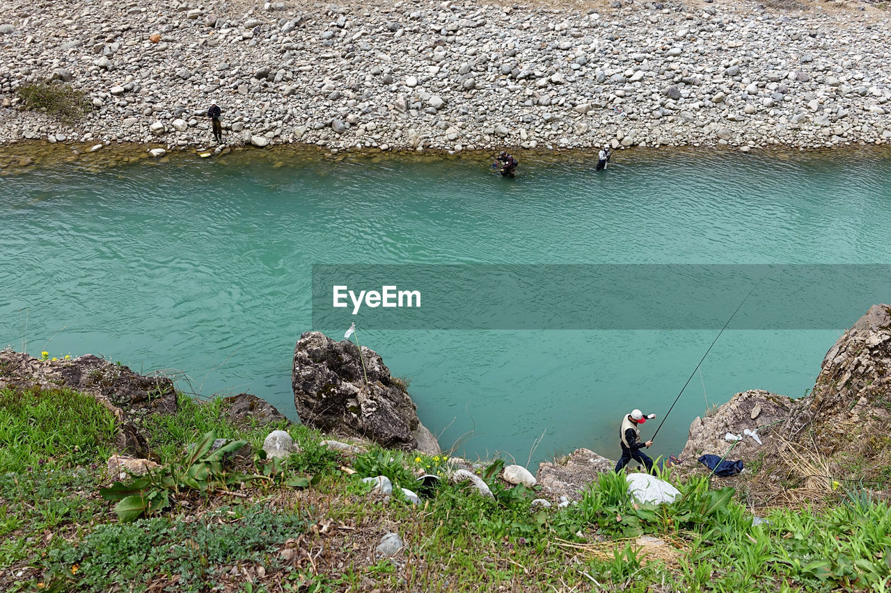 High angle view of people fishing in river