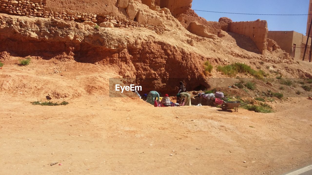 PEOPLE ON SAND DUNE