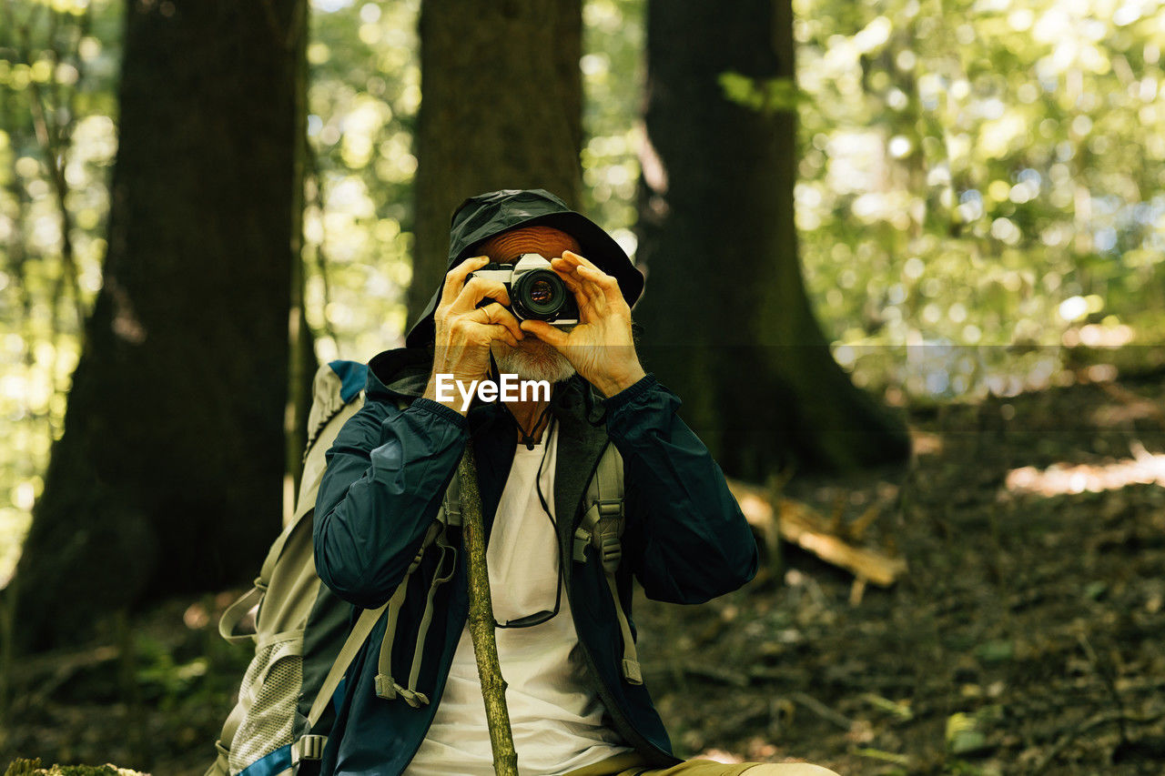 side view of young woman photographing through camera