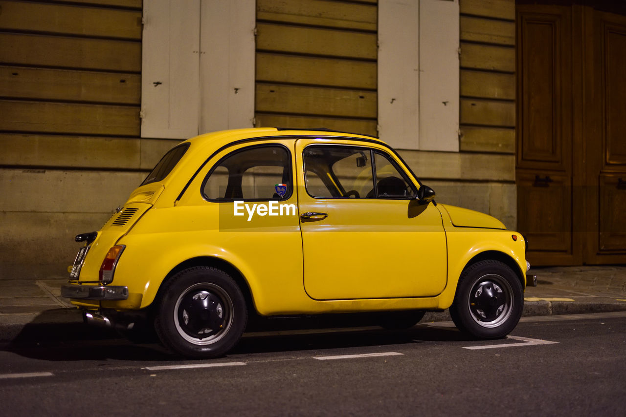 car, vehicle, land vehicle, mode of transportation, transportation, motor vehicle, yellow, taxi, architecture, city car, yellow taxi, city, street, retro styled, automobile, travel, road, vintage car, antique car, building exterior, no people, built structure, wheel, old, city life, city street, subcompact car