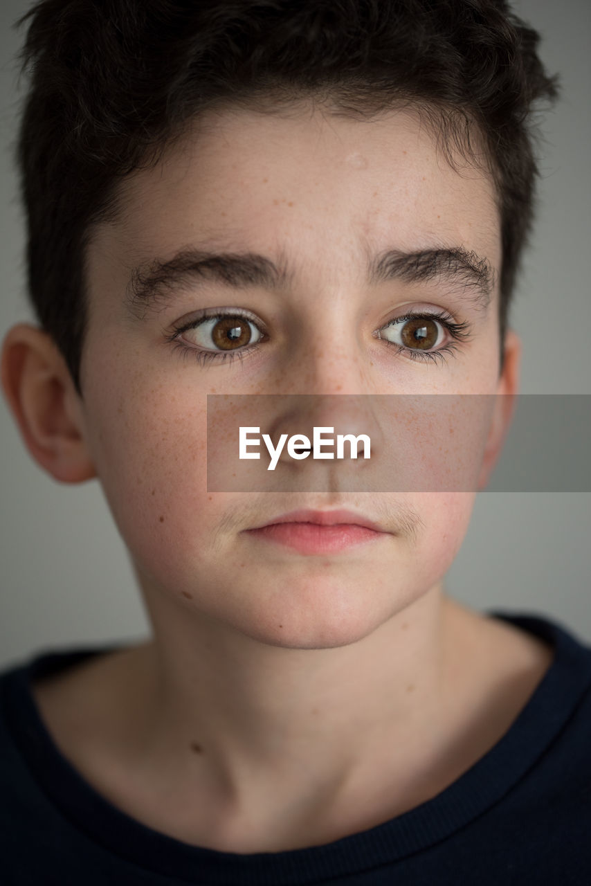Close-up of teenage boy looking away