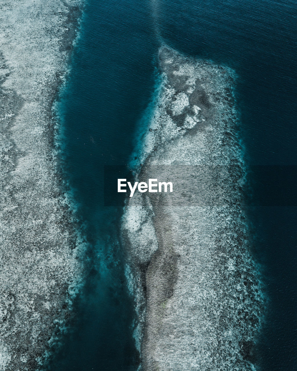 Aerial view of rock formation by sea
