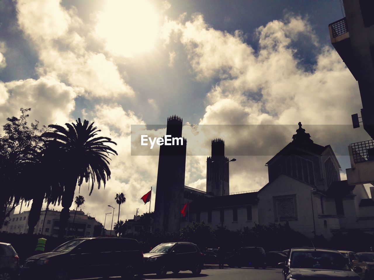 CITY STREET AGAINST CLOUDY SKY