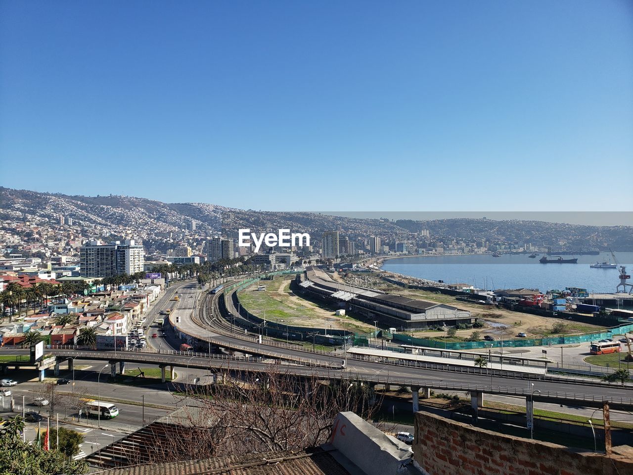 HIGH ANGLE VIEW OF BUILDINGS AGAINST CLEAR BLUE SKY