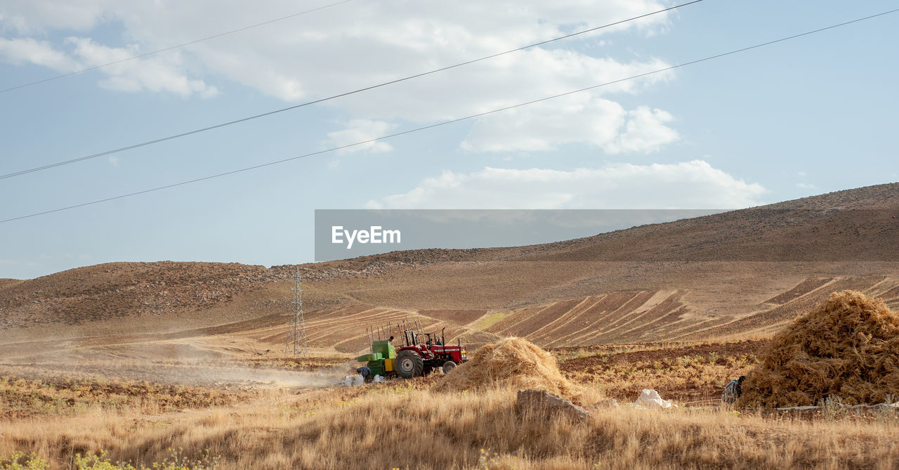 SCENIC VIEW OF LAND AND MOUNTAINS AGAINST SKY