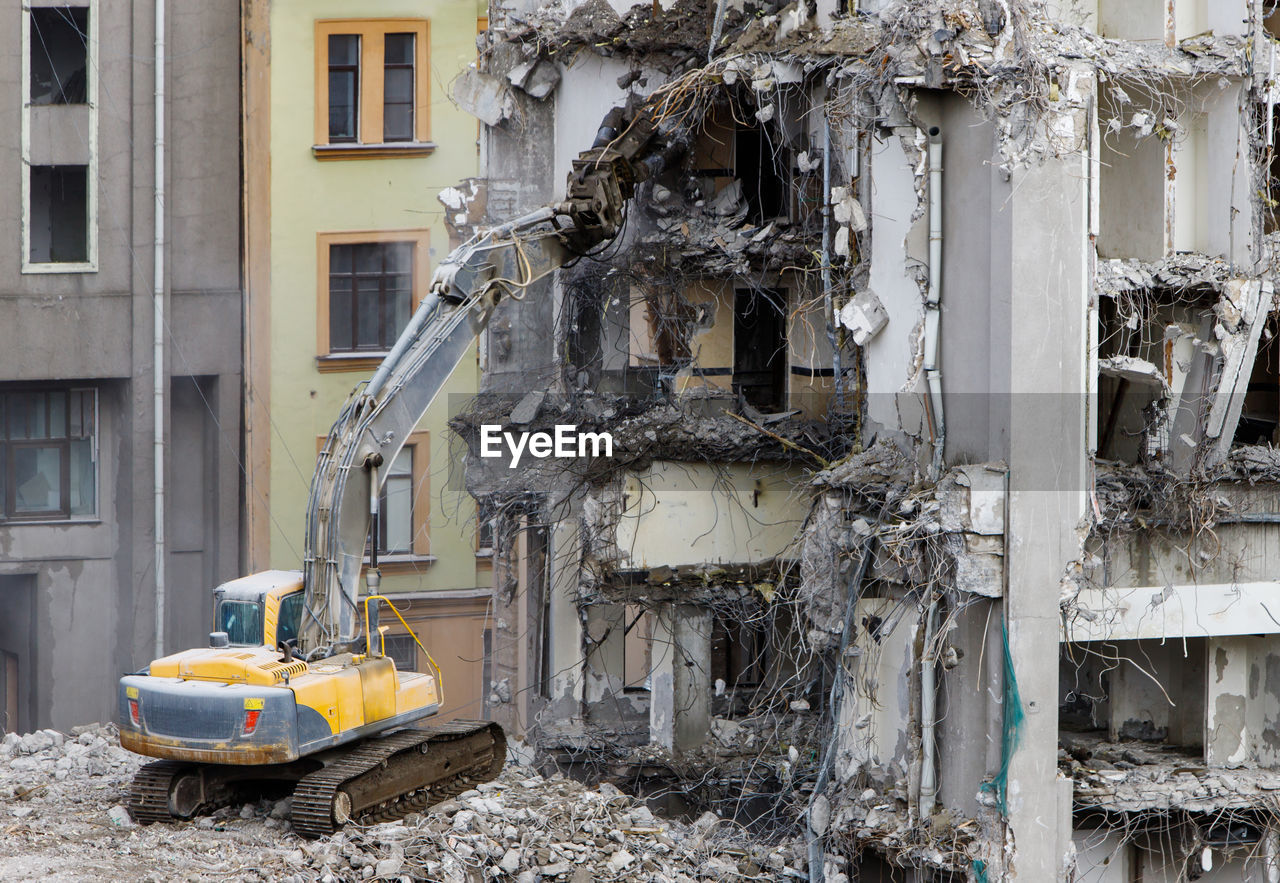 Building of former hotel demolition for new construction, usingspecial hydraulic excavator-destroyer