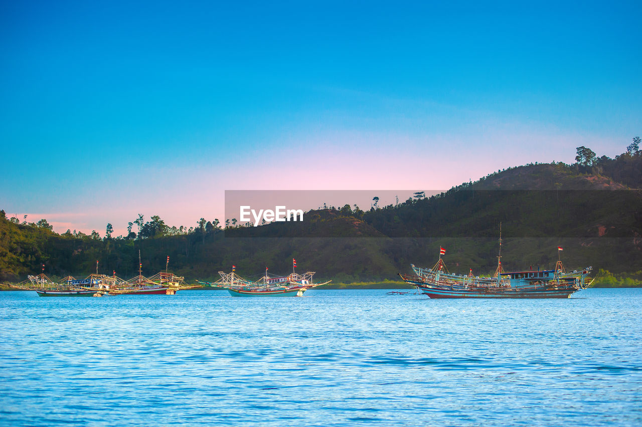 Scenic view of sea against clear blue sky