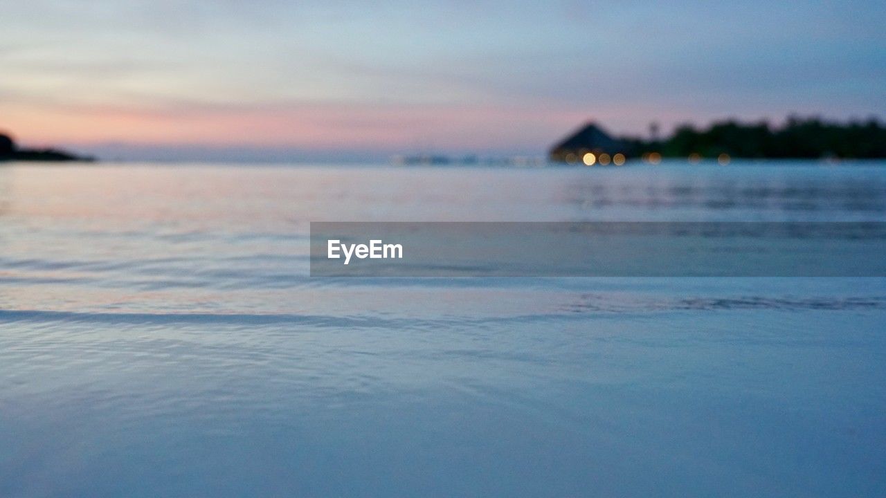 water, sky, reflection, scenics - nature, sea, tranquility, wave, ocean, nature, tranquil scene, sunset, beauty in nature, horizon, no people, shore, cloud, land, dusk, beach, outdoors, idyllic, environment, sunlight, coast, blue, landscape, evening, wind wave, body of water, travel destinations
