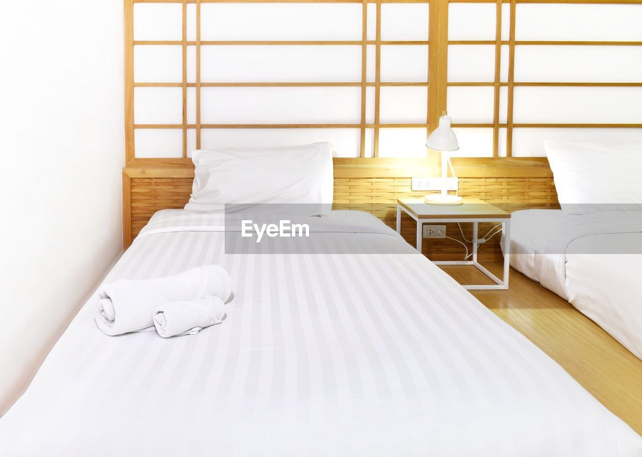 WHITE IMAGE OF A BED IN THE BEDROOM