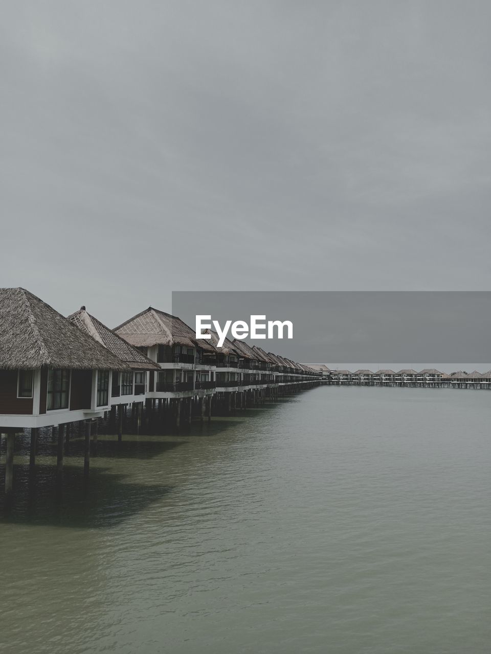 Scenic view of sea and houses against sky