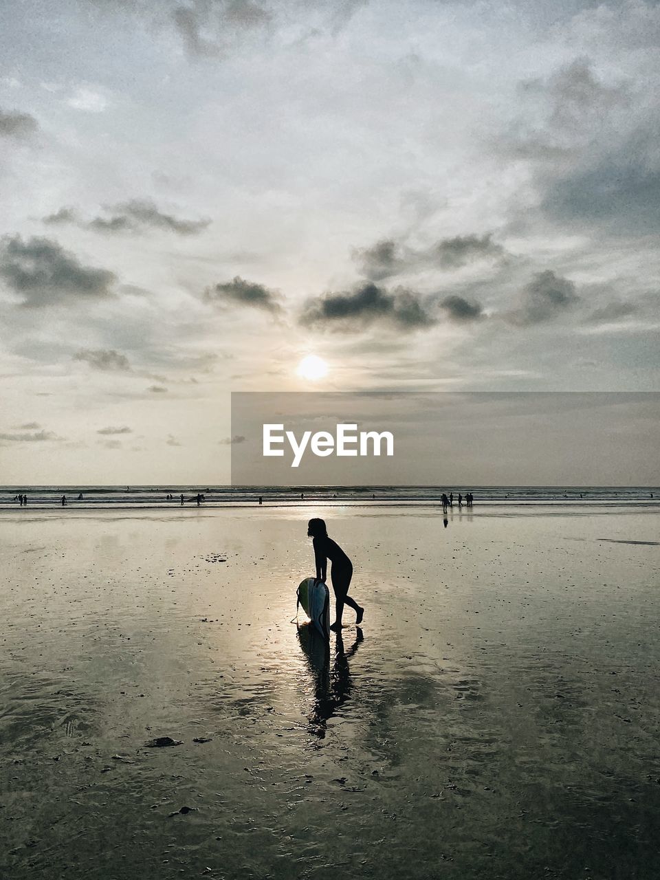 FULL LENGTH OF WOMAN ON BEACH AGAINST SKY