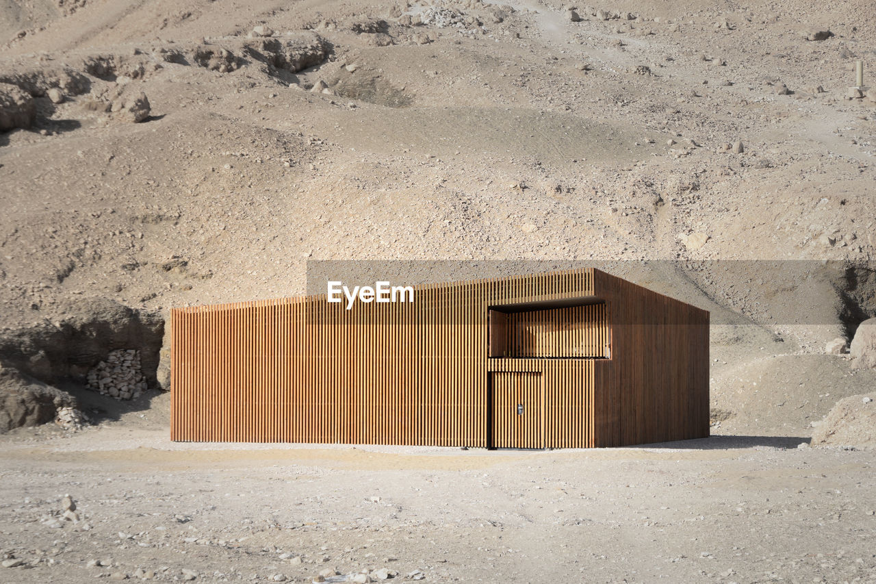 Exterior of geometric wooden house in desert environment