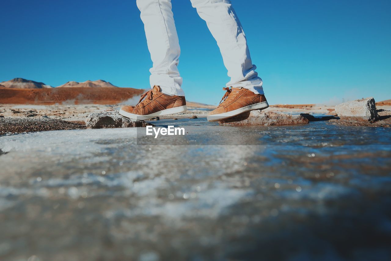 Low section of person standing on rock