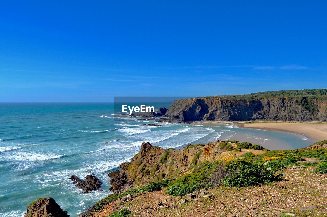 Scenic view of sea against blue sky