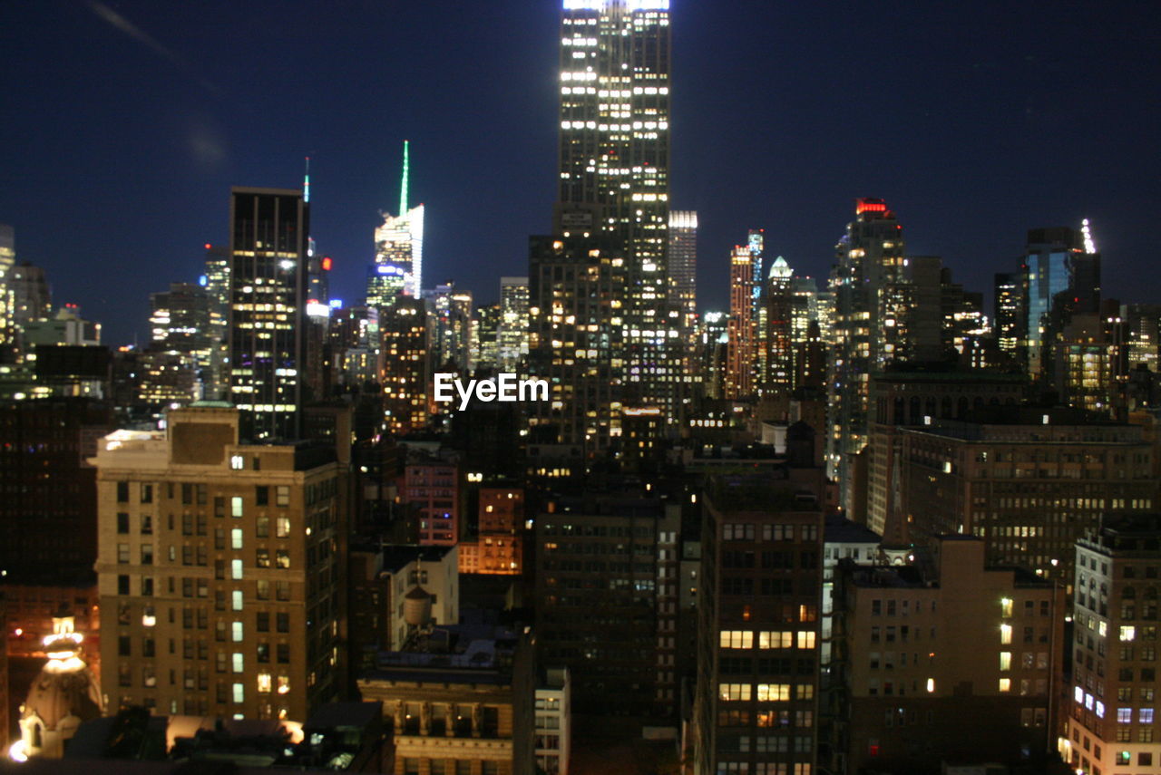 ILLUMINATED SKYSCRAPERS AT NIGHT