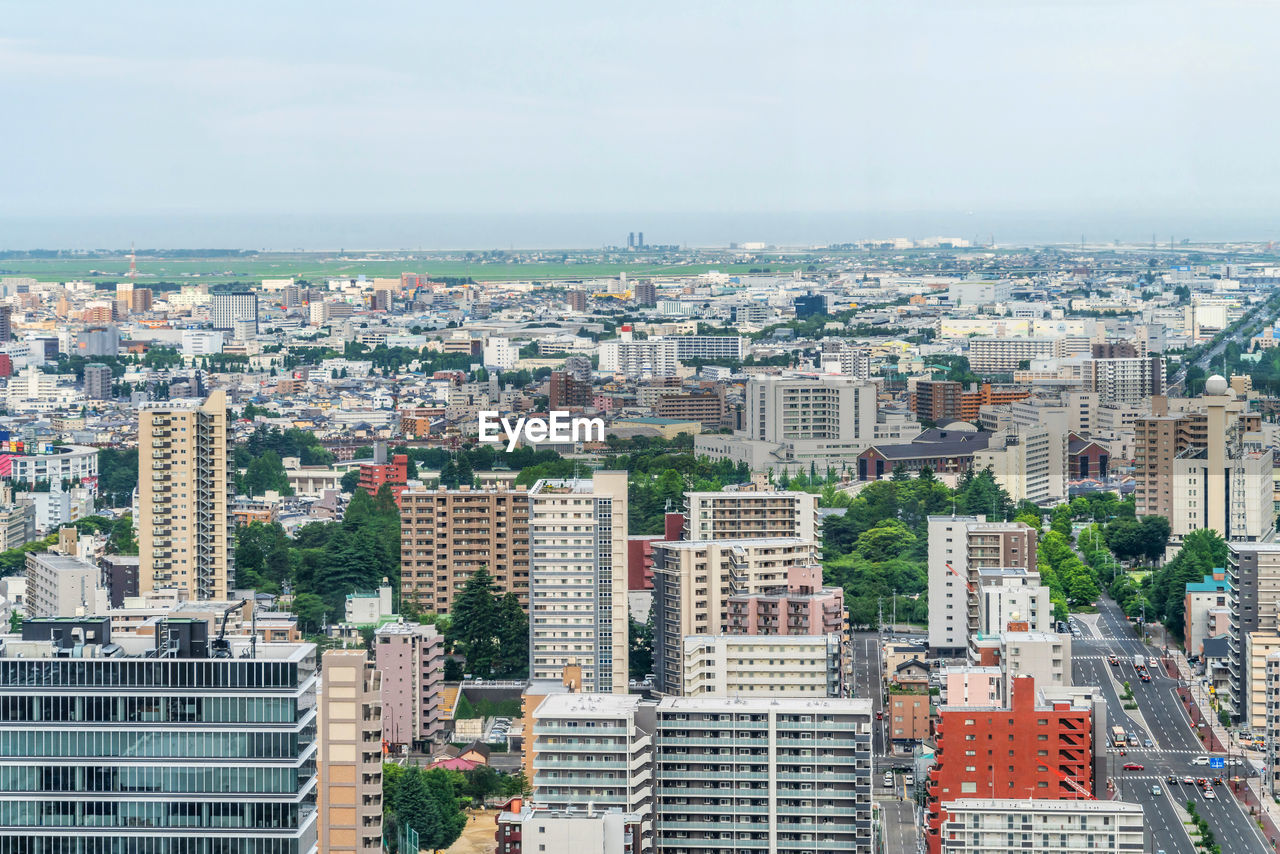 HIGH ANGLE VIEW OF BUILDINGS AGAINST SKY