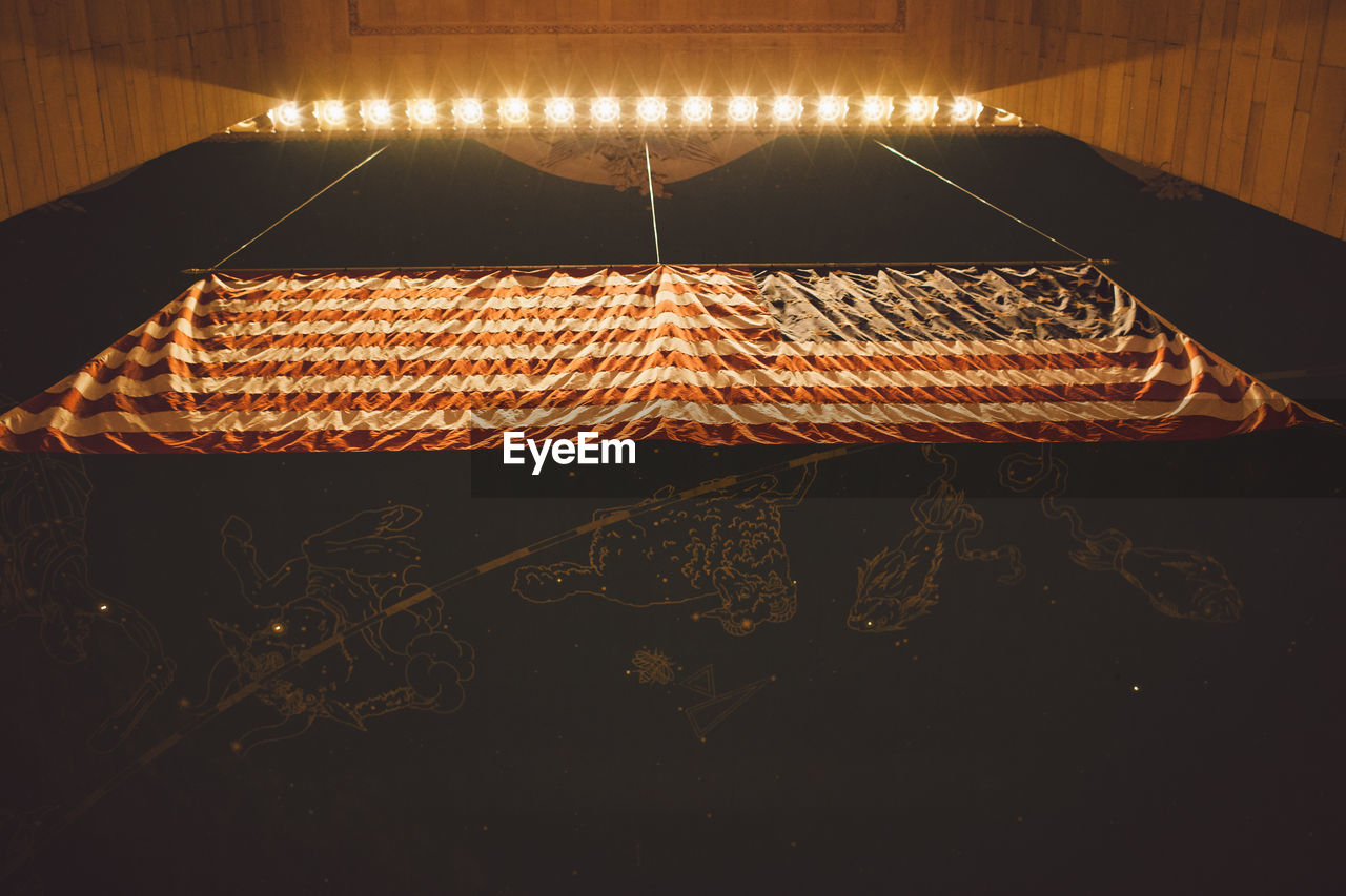 CLOSE-UP OF ILLUMINATED WICKER BASKET AT NIGHT