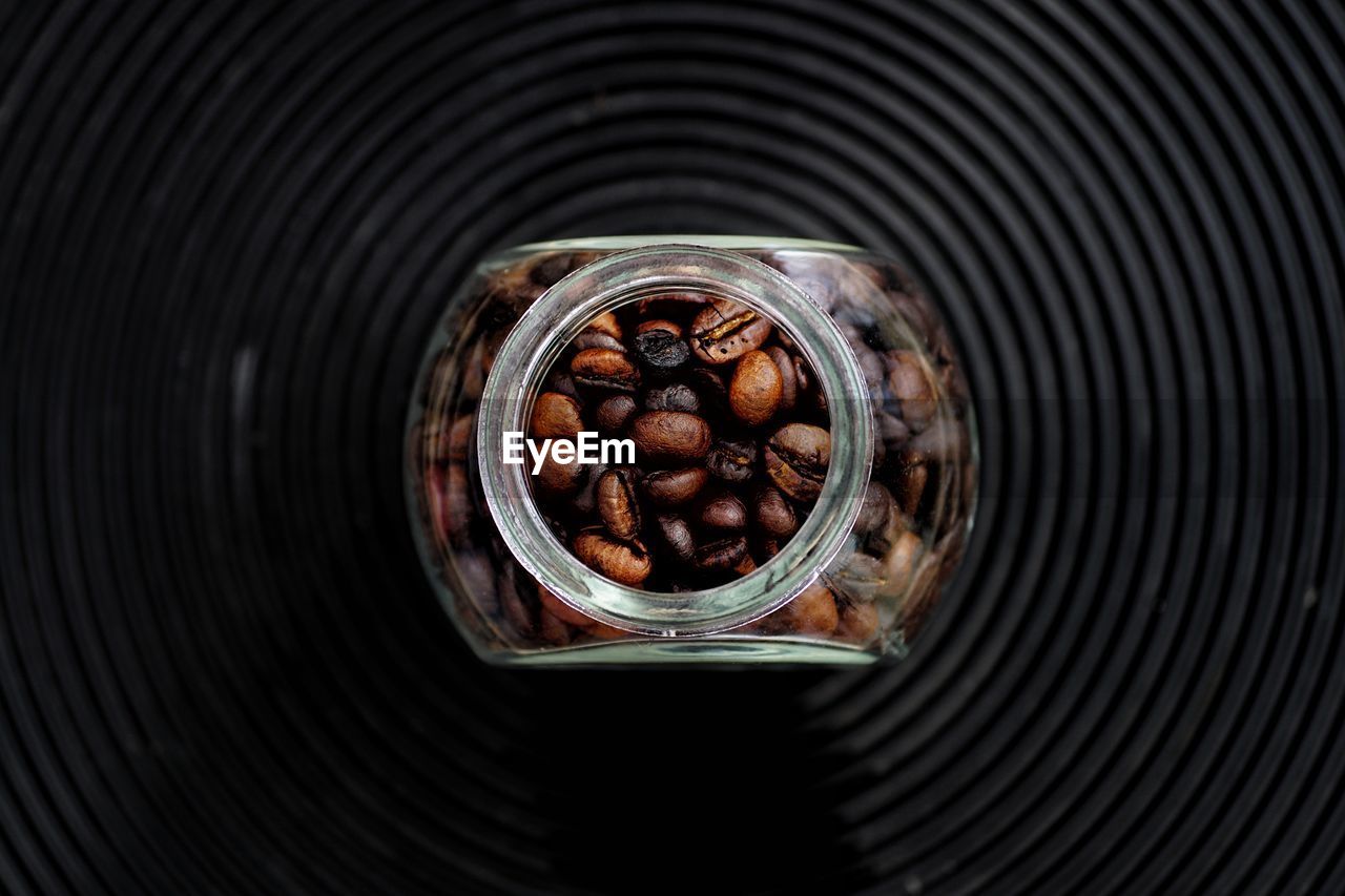 High angle view of coffee beans in glass on table