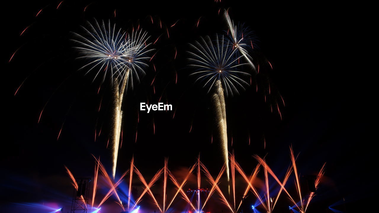 Low angle view of firework display at night