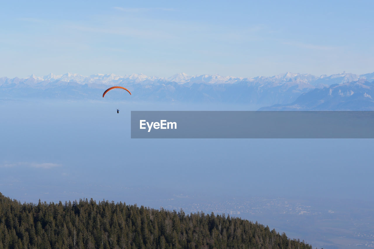 low angle view of person paragliding against sky