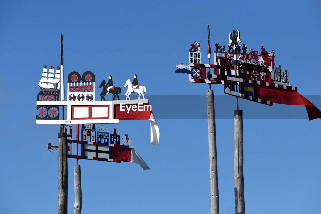 LOW ANGLE VIEW OF SIGN AGAINST CLEAR BLUE SKY