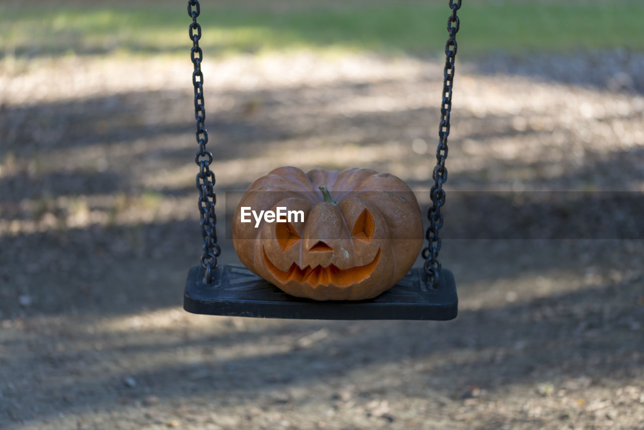 Close-up of swing hanging on metal