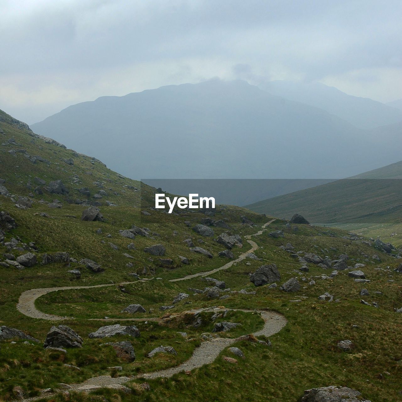 Scenic view of mountains against sky during foggy weather