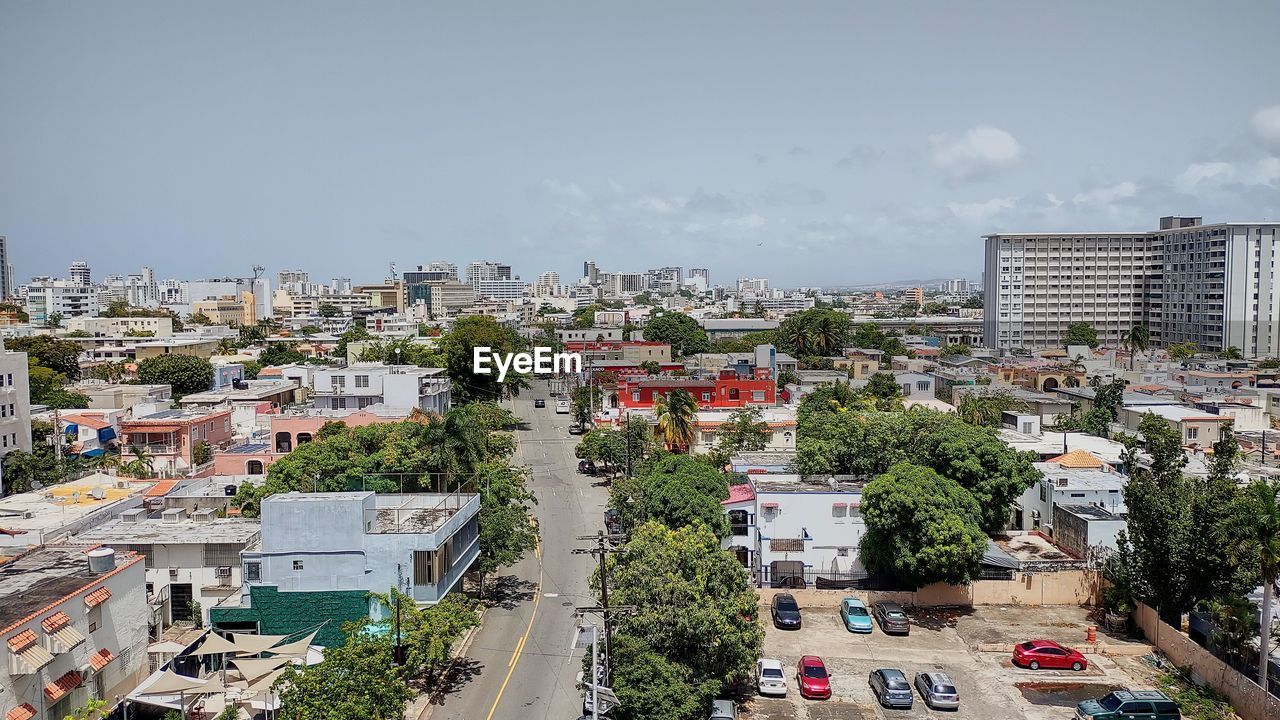 High angle view of trees and buildings against sky