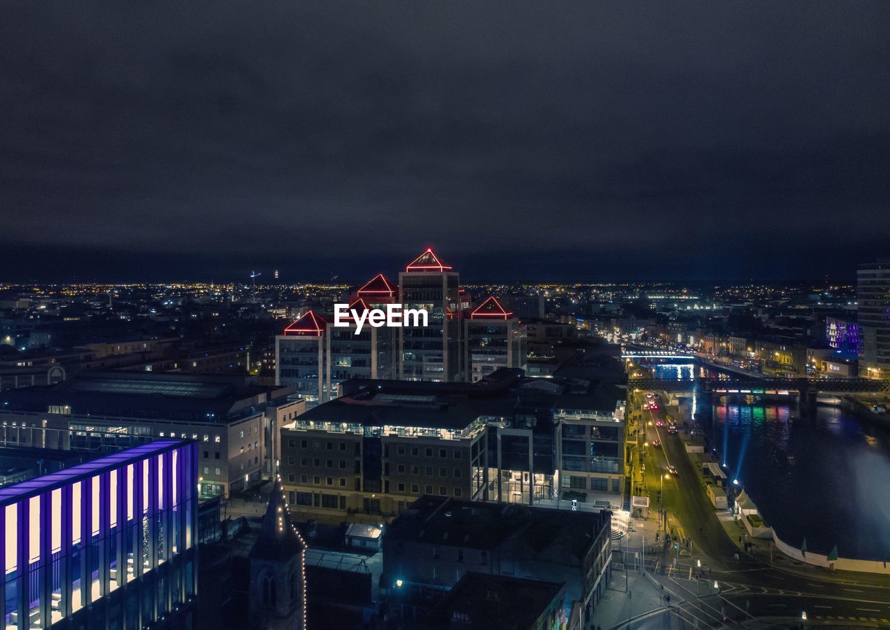 High angle view of buildings lit up at night