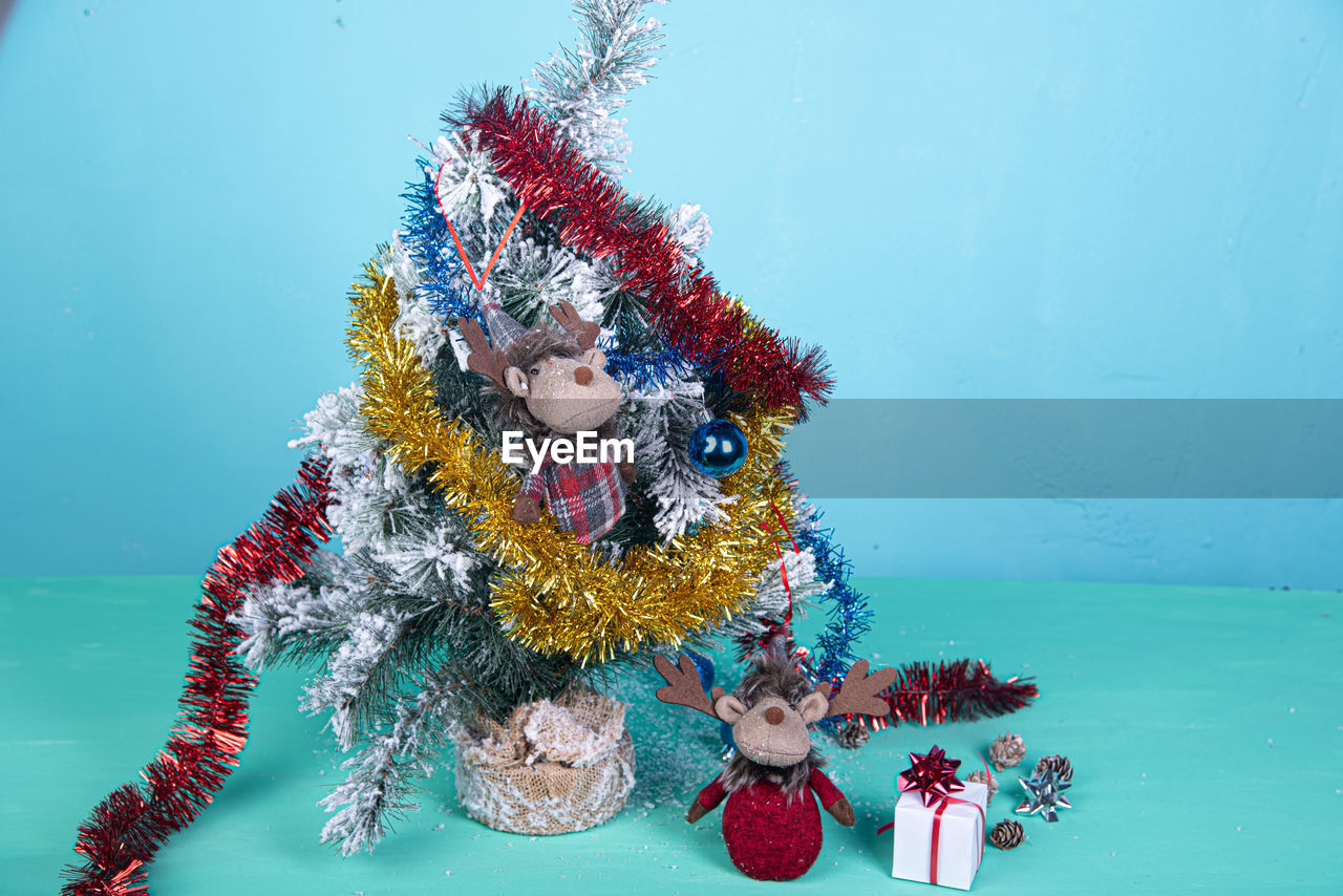 Christmas tree against wall on table