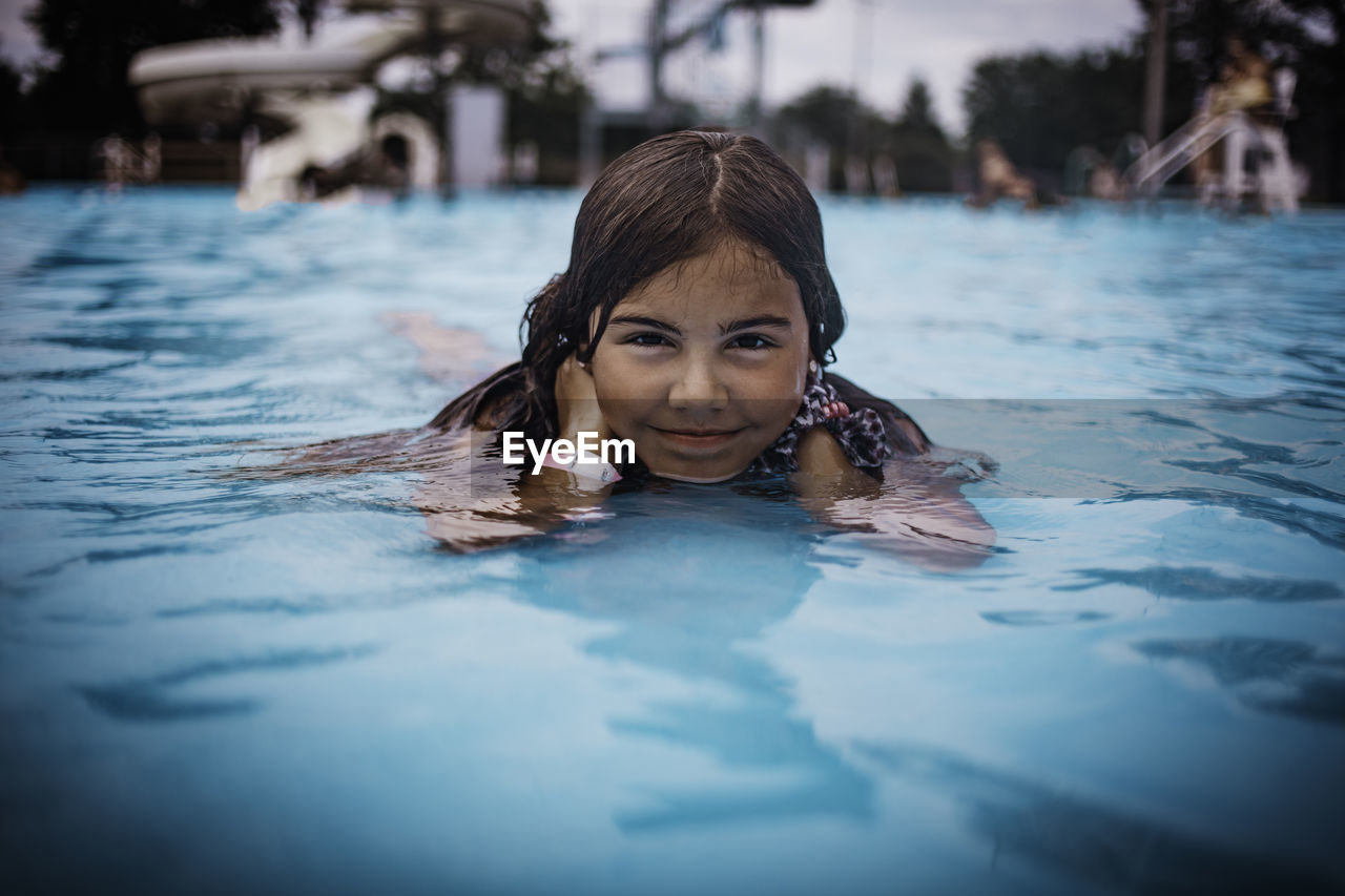 Portrait of girl swimming in pool