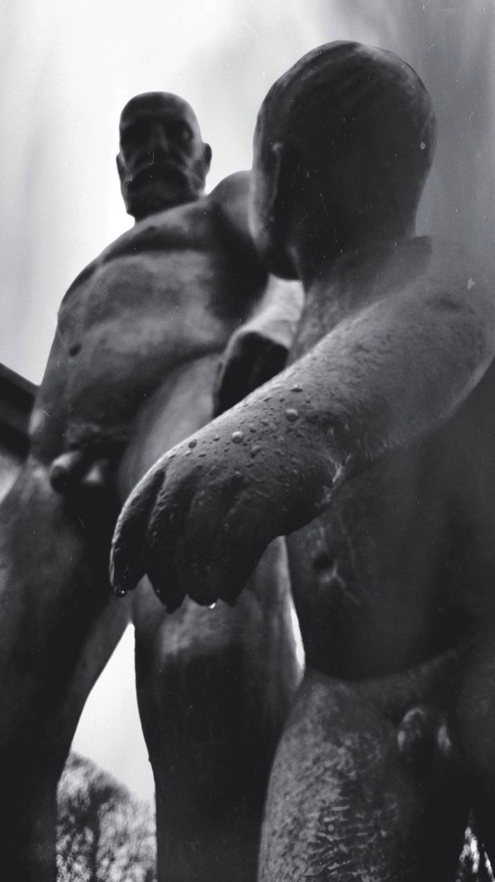 Low angle view of statues against sky