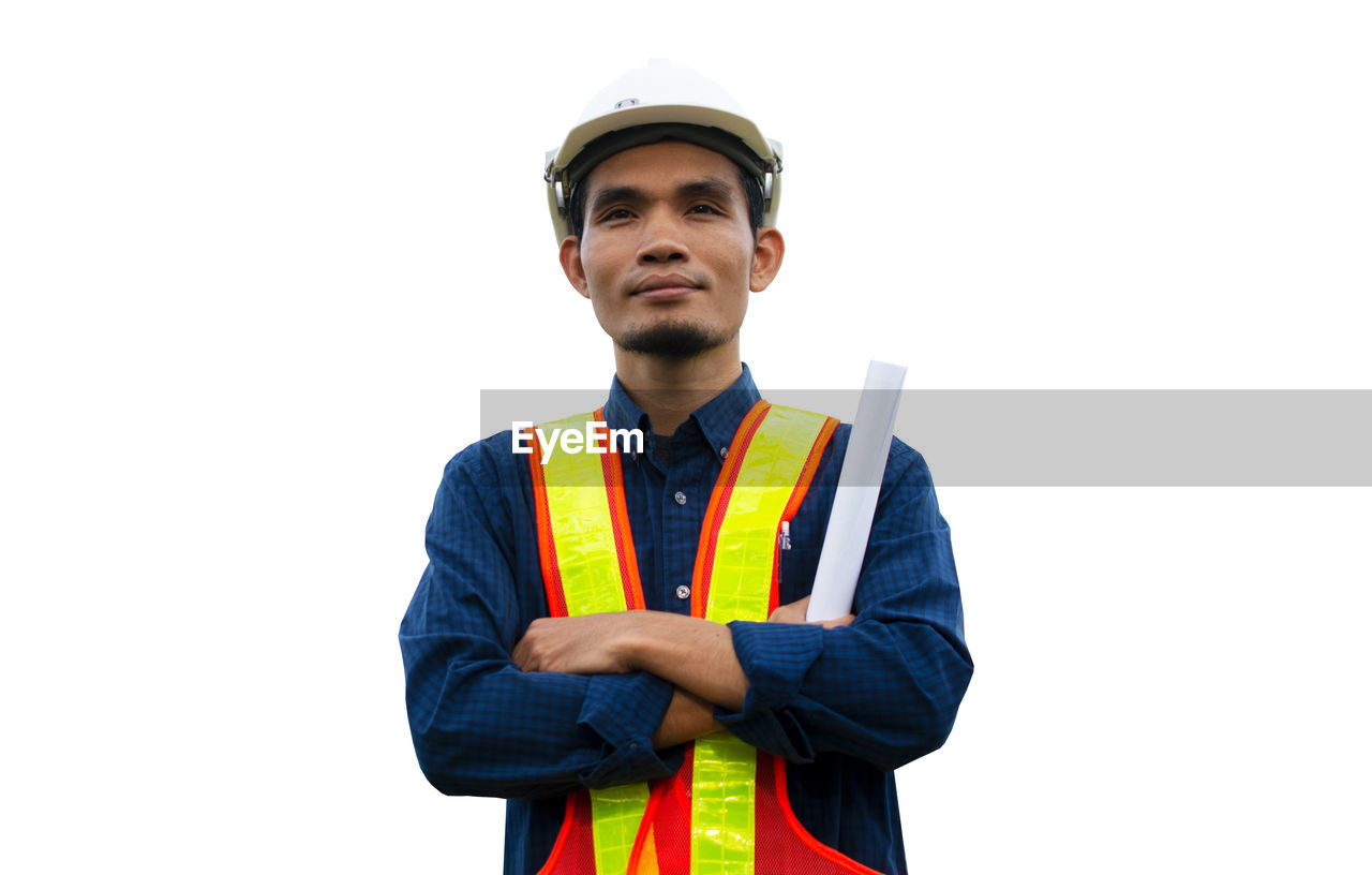 MAN STANDING AGAINST WHITE BACKGROUND