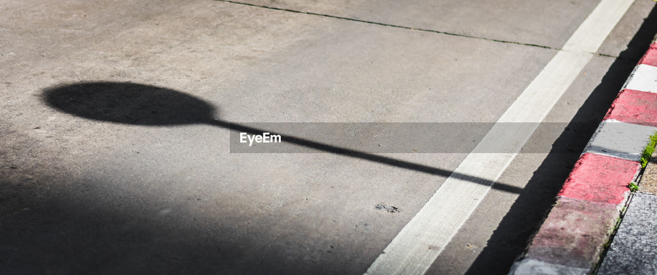 HIGH ANGLE VIEW OF SHADOW ON SUNLIGHT