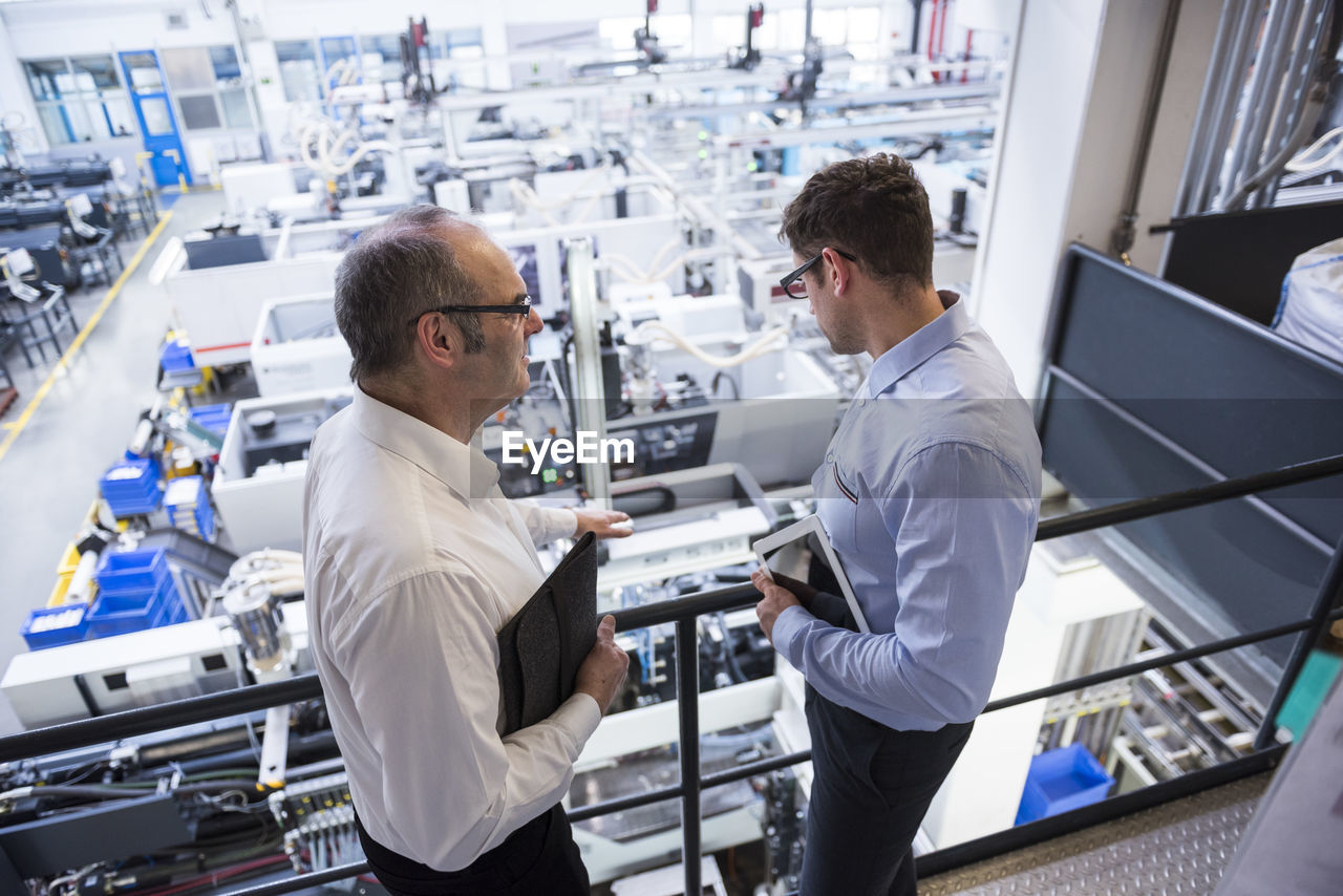 Two men talking in factory shop floor