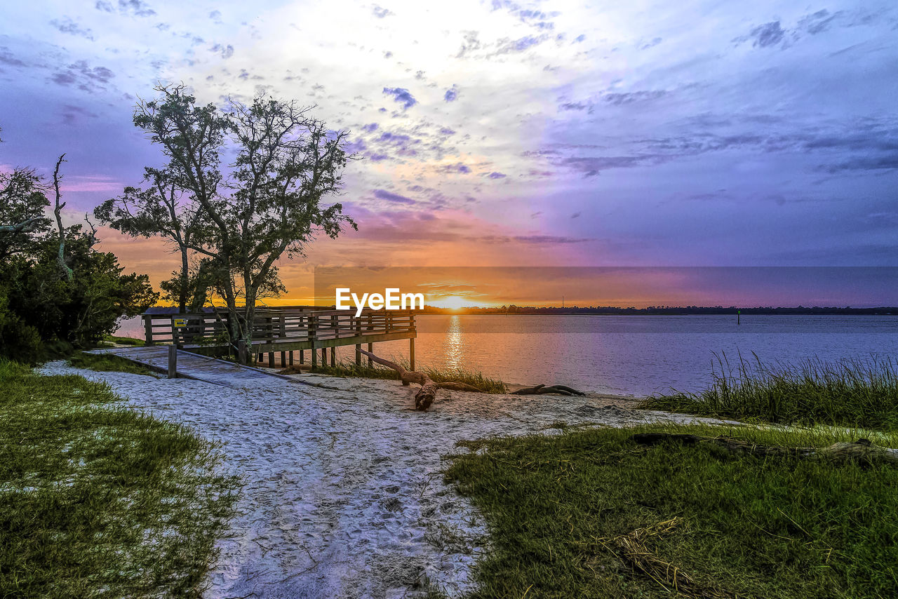 SCENIC VIEW OF SEA AGAINST ORANGE SKY