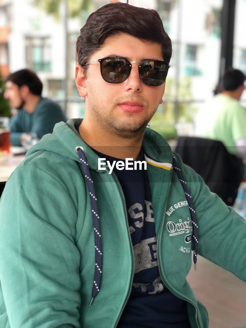 Portrait of young man wearing sunglasses standing outdoors