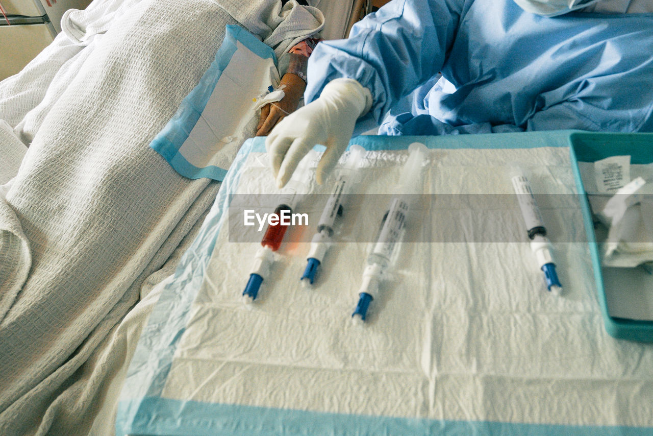 High angle view of medical syringes on white cloth in a hospital