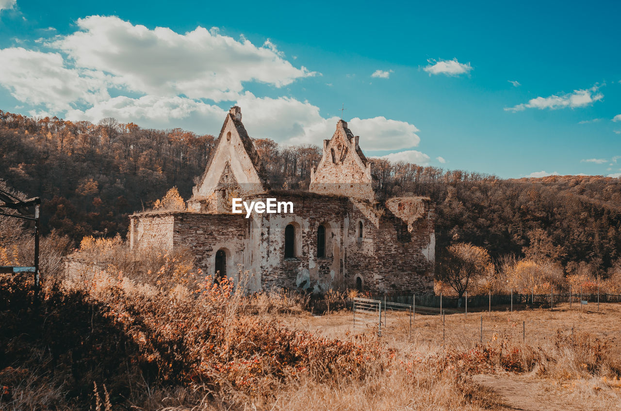 Old ruined fortress in woods. blue sky with white clouds. beautiful picture for puzzles.