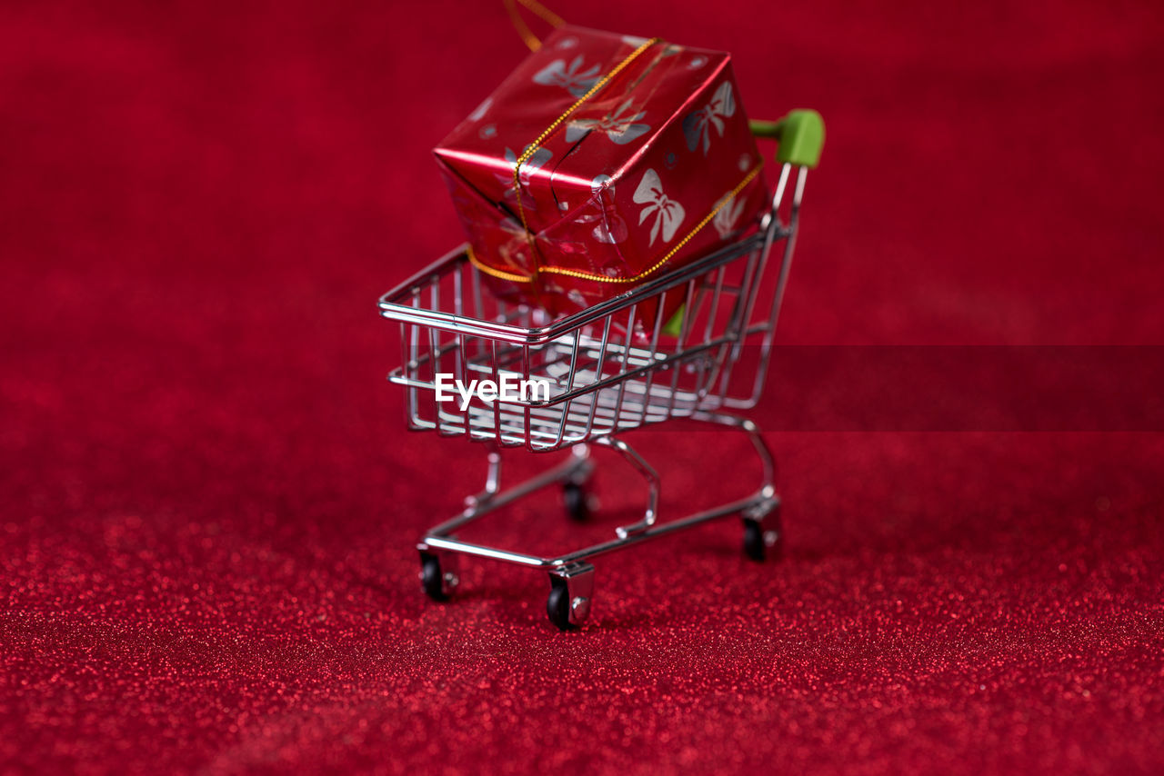 Close-up of christmas present on shopping cart