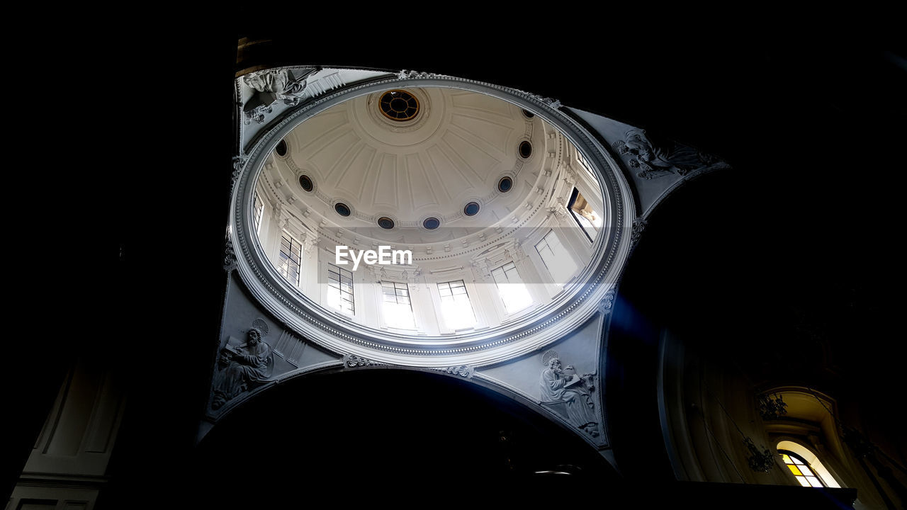 LOW ANGLE VIEW OF ILLUMINATED LAMP AGAINST DARK SKY