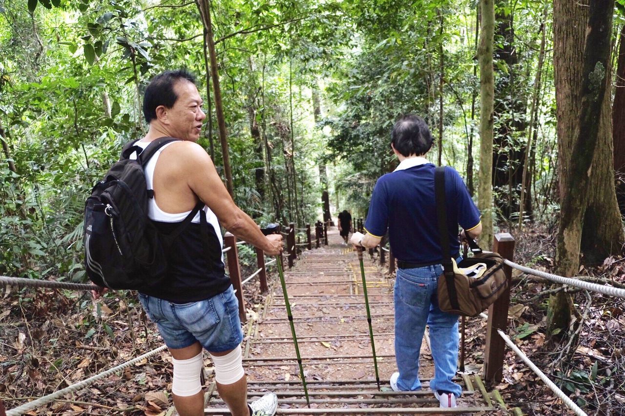 MAN STANDING IN FOREST