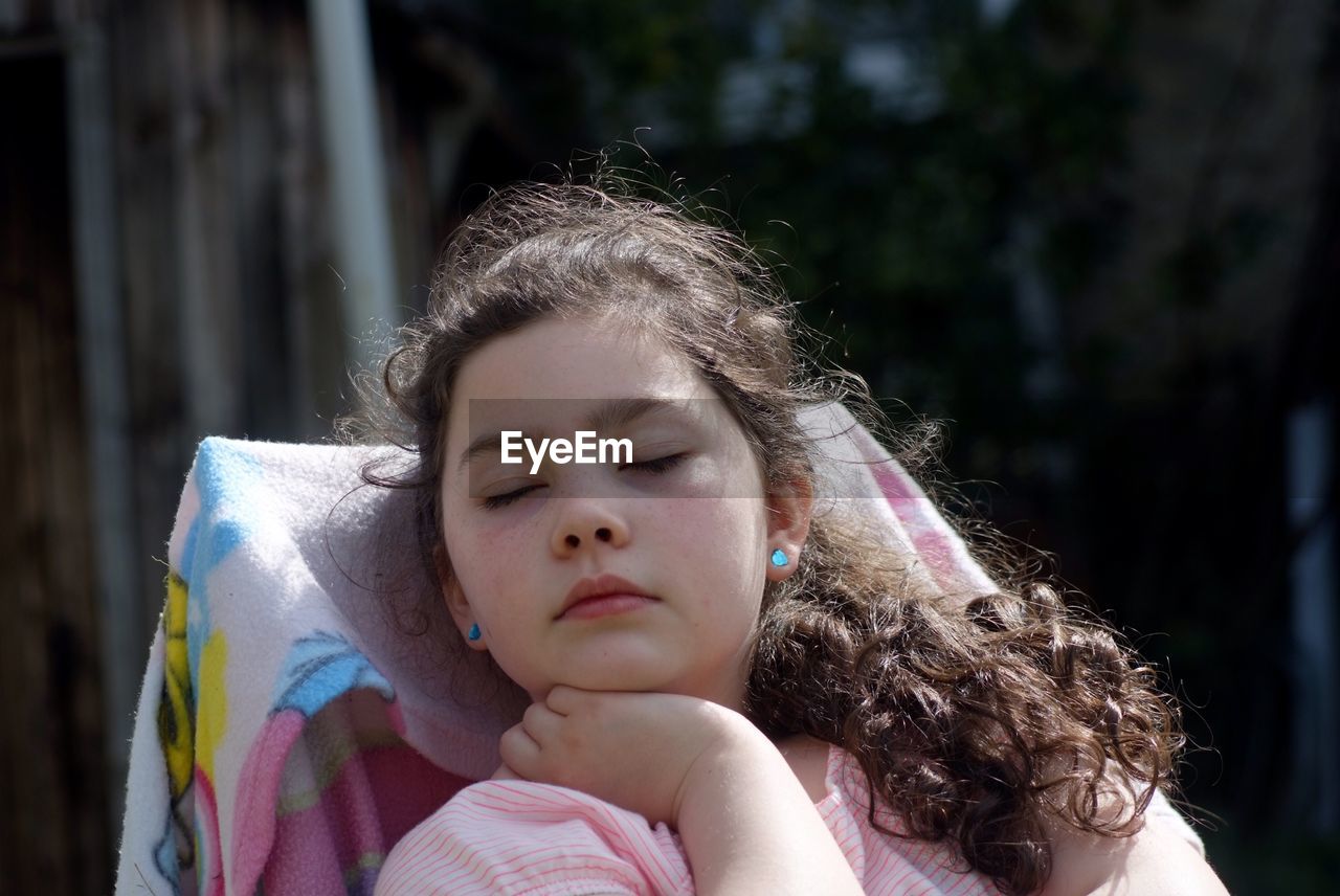 Girl napping in backyard