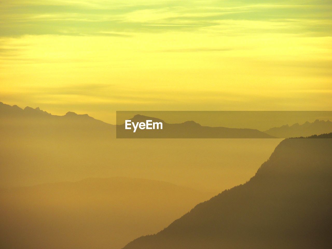 Scenic view of mountains against sky during foggy weather