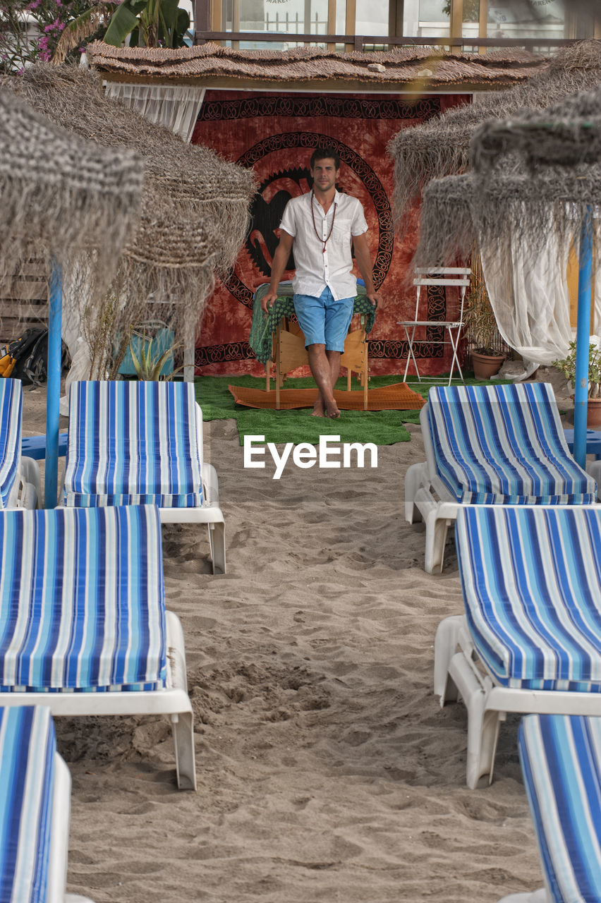 Full length of mid adult man standing at beach