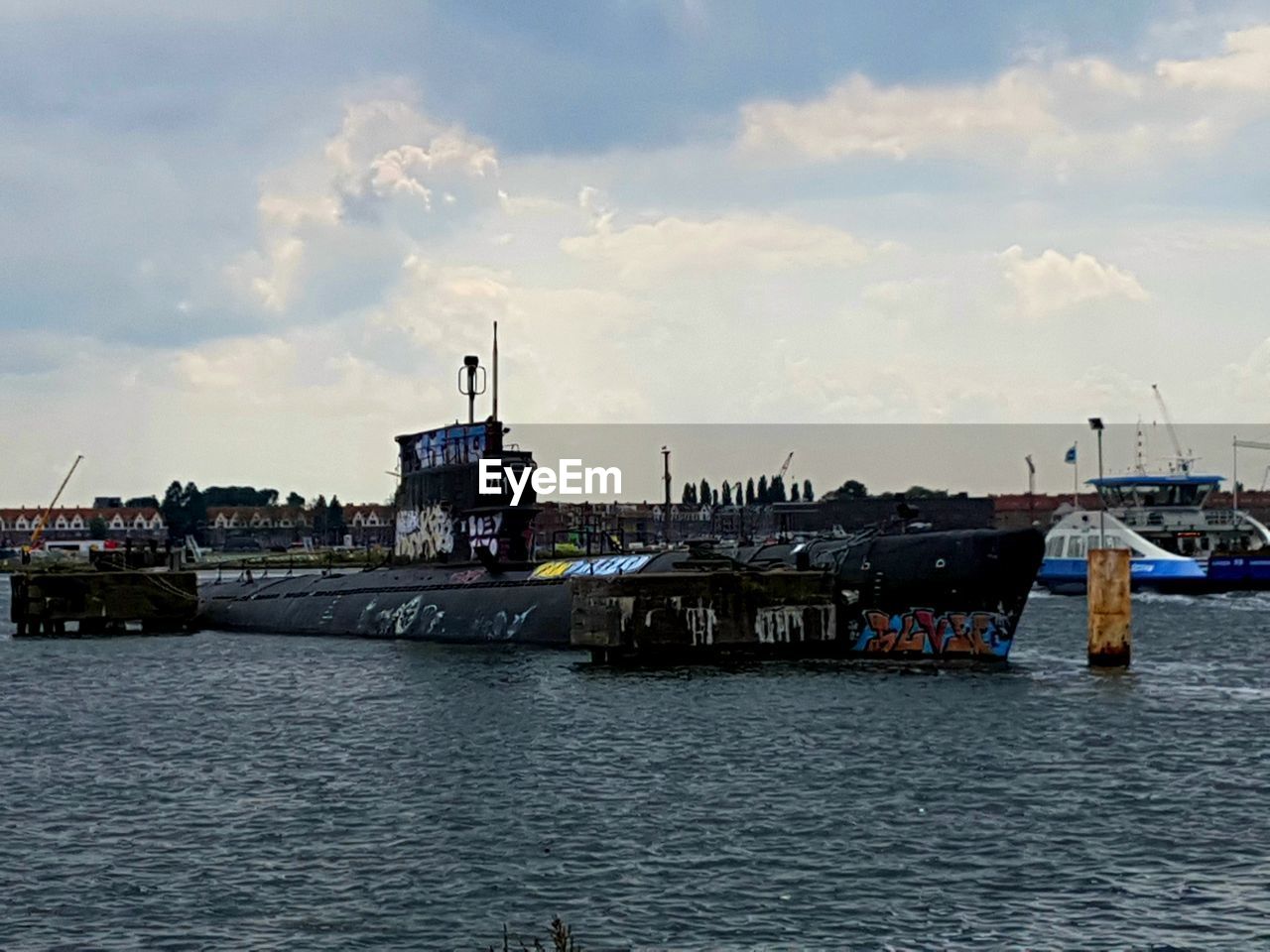 SHIP IN HARBOR AGAINST SKY